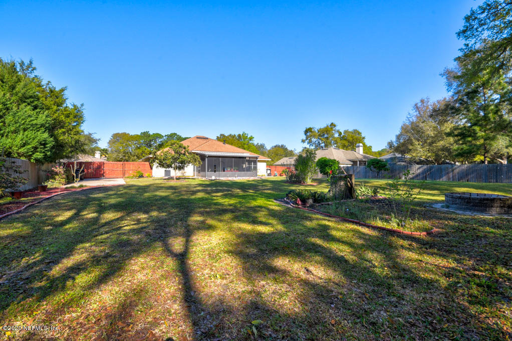 97071 Castle Ridge Drive Yulee, FL 32097 - Photo 25 of 26 a front view of a house with a yard