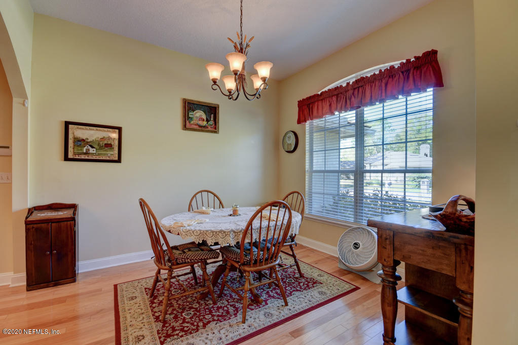 97071 Castle Ridge Drive Yulee, FL 32097 - Photo 4 of 26 a view of a dining room with furniture and chandelier