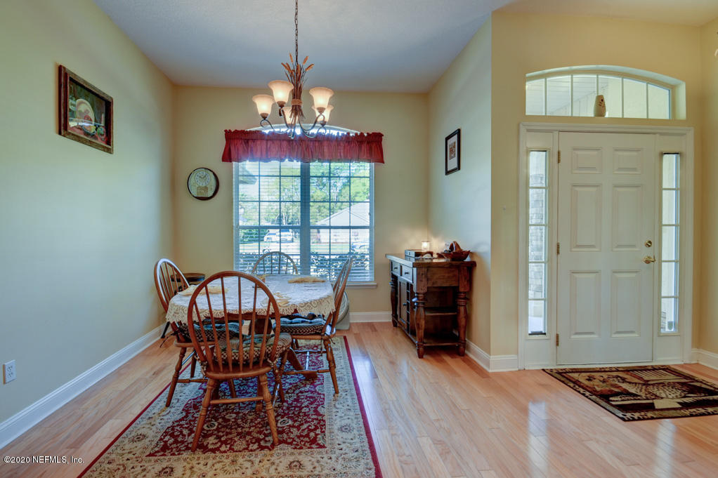 97071 Castle Ridge Drive Yulee, FL 32097 - Photo 5 of 26 a view of a dining room with furniture window and wooden floor