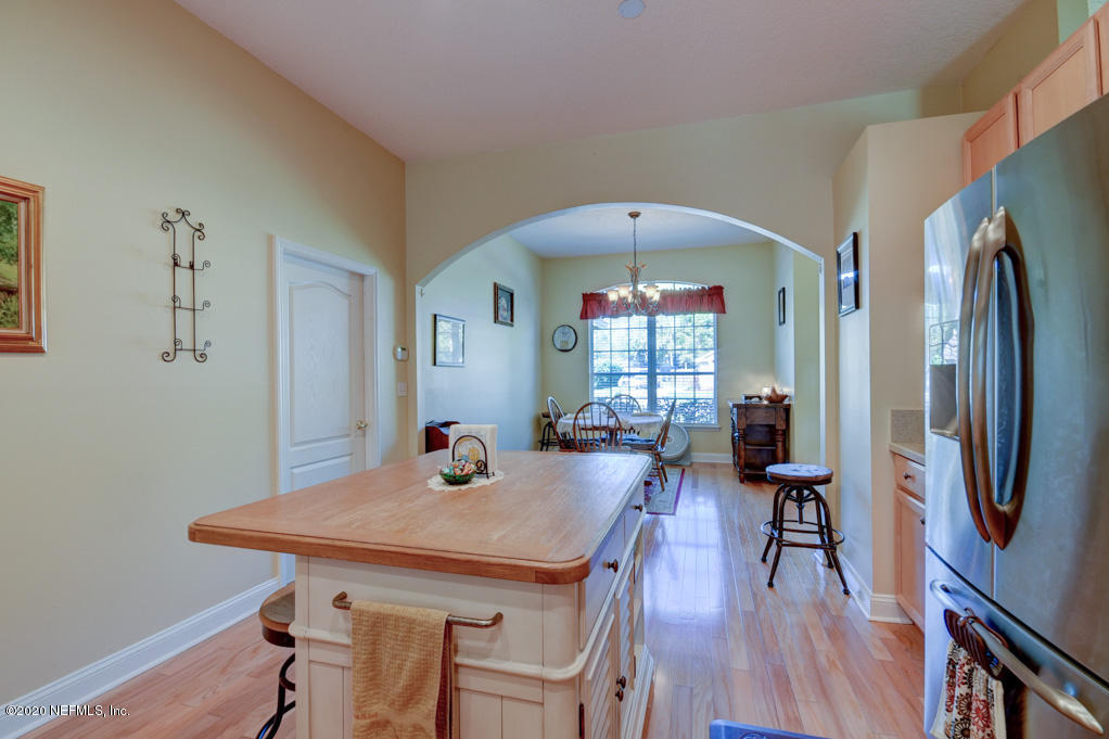 97071 Castle Ridge Drive Yulee, FL 32097 - Photo 10 of 26 a view of a dining room with furniture and a chandelier