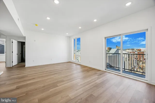 a view of a room with wooden floor