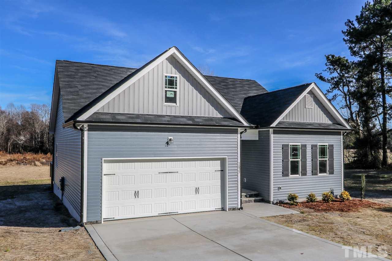 1035 2 Claude Road Willow Spring, NC 27592 - Photo 2 of 18 a front view of a house with a garage