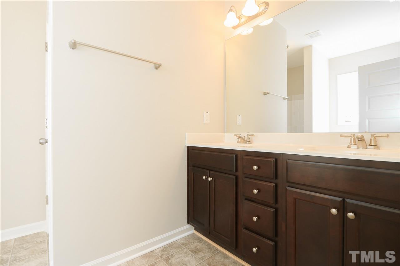 1035 2 Claude Road Willow Spring, NC 27592 - Photo 12 of 18 a bathroom with a double vanity sink and mirror