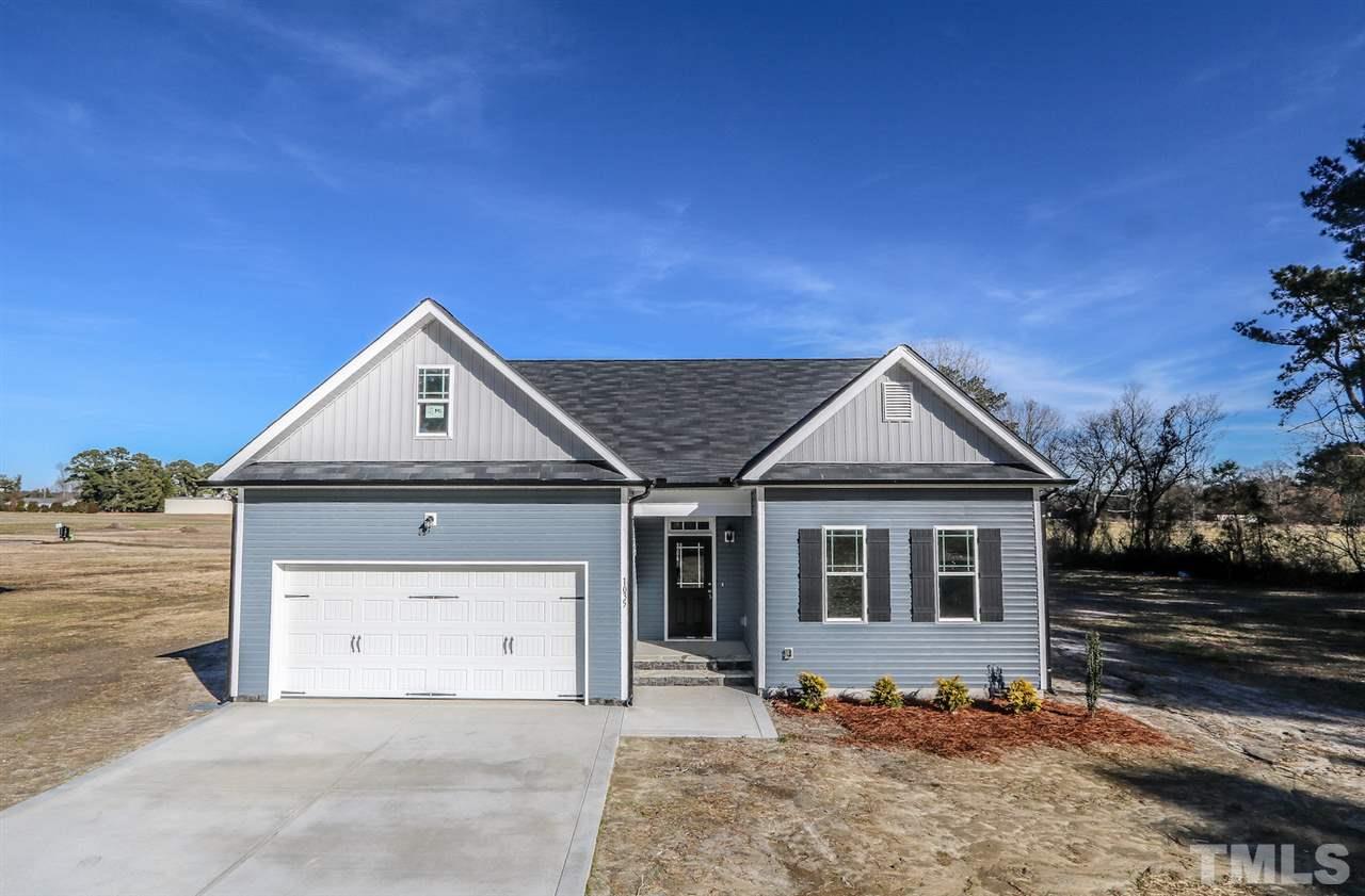 1035 2 Claude Road Willow Spring, NC 27592 - Photo 18 of 18 a front view of a house with a yard
