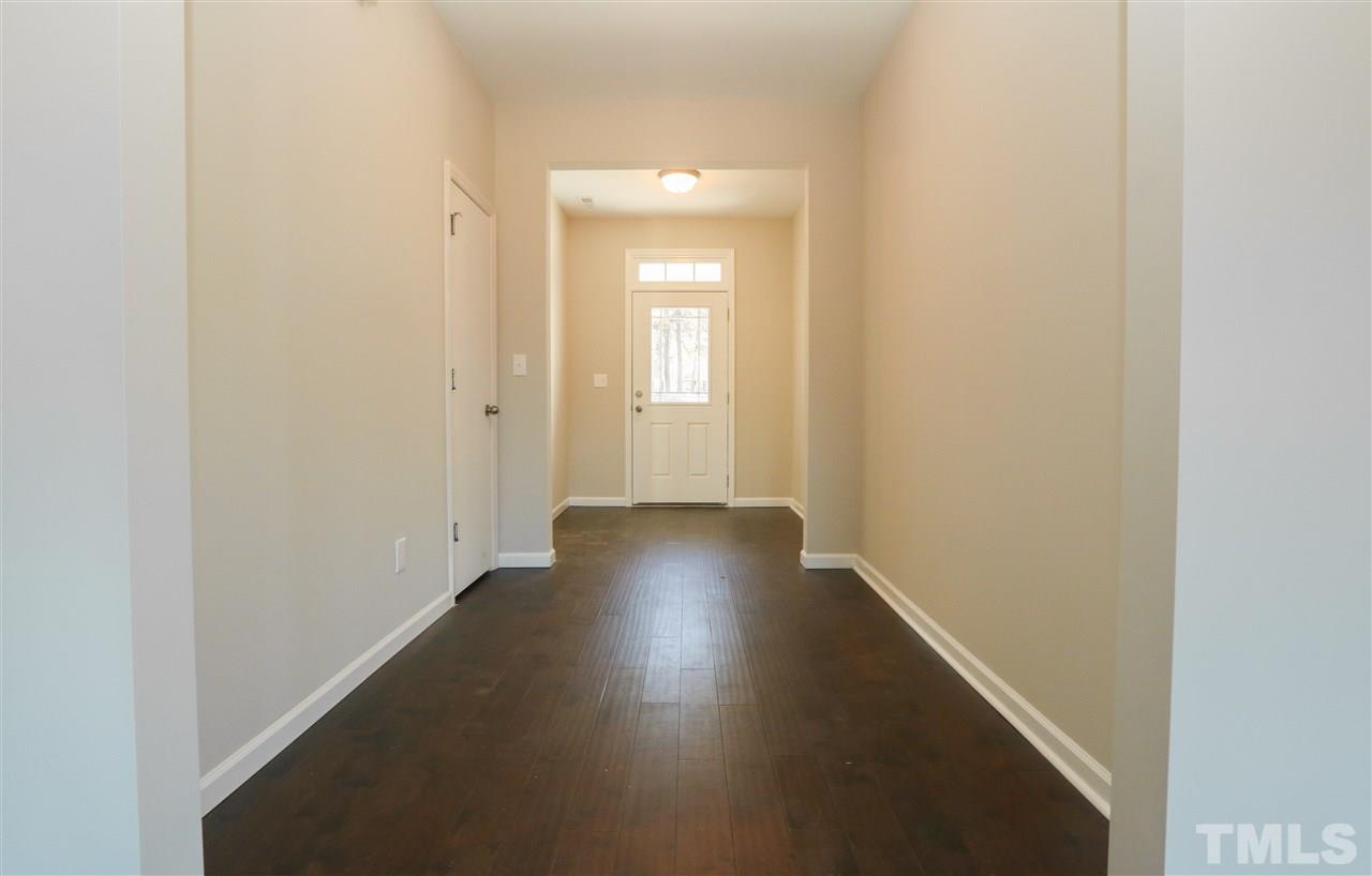 1035 2 Claude Road Willow Spring, NC 27592 - Photo 3 of 18 a view of a hallway with wooden floor