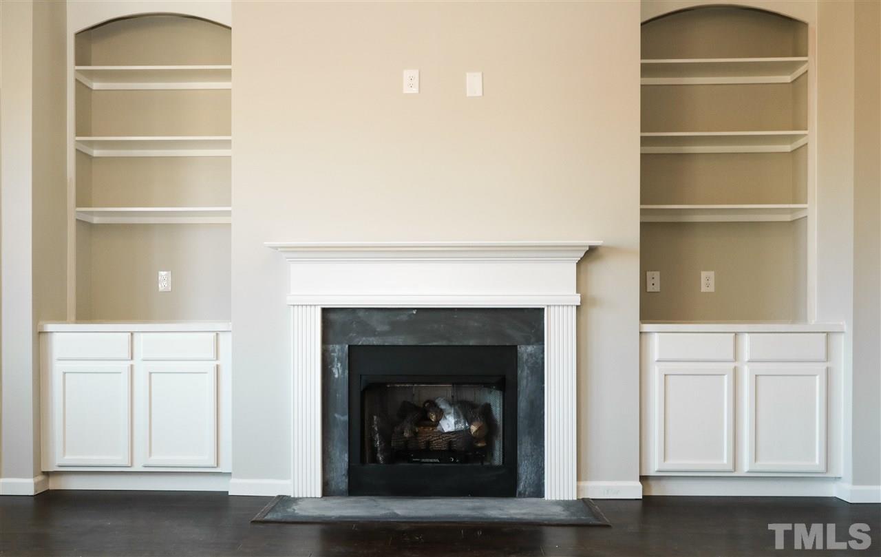 1035 2 Claude Road Willow Spring, NC 27592 - Photo 6 of 18 a living room with a fireplace
