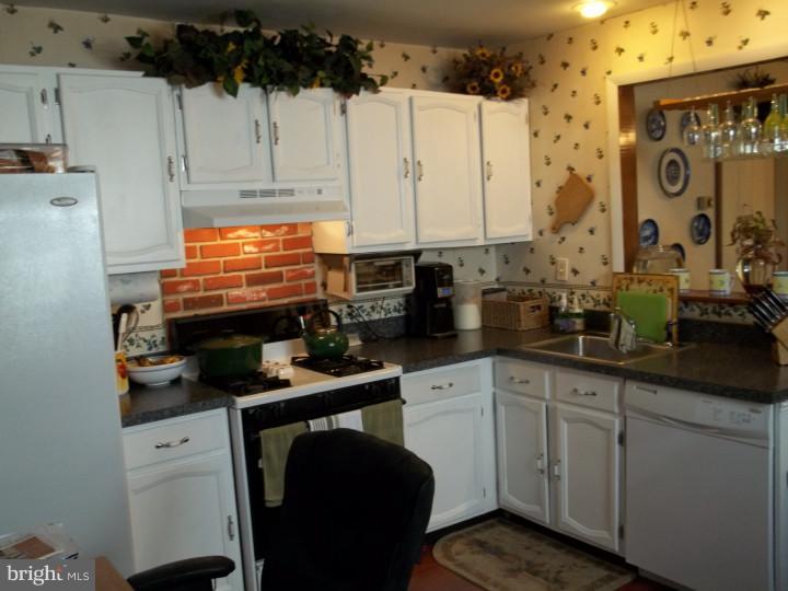 1007 Dale Road Secane, PA 19018 - Photo 8 of 14 a kitchen with stainless steel appliances a sink a stove and white cabinets