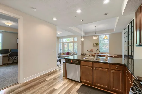 a kitchen with granite countertop a sink and cabinets