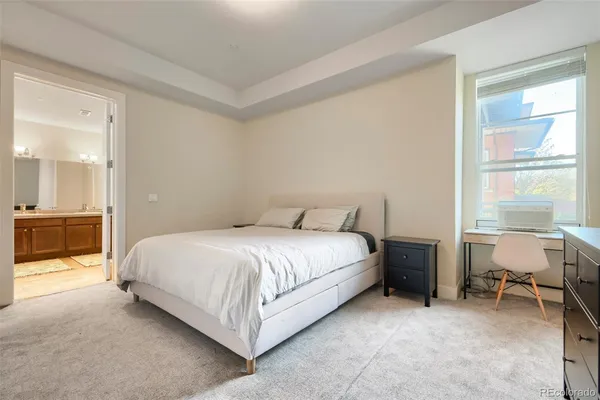 a bed room with a bed and a chair