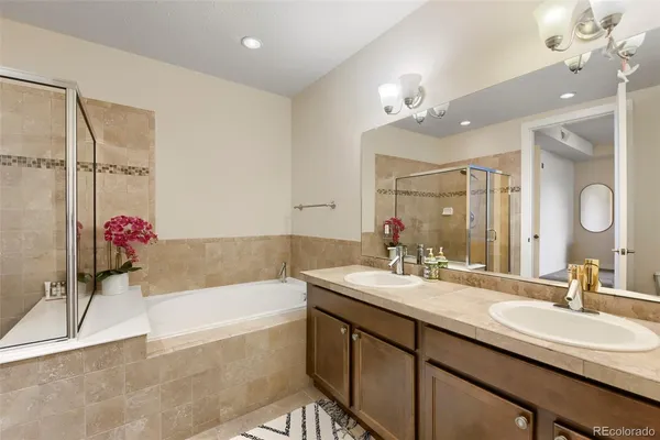 a bathroom with a tub sink and mirror