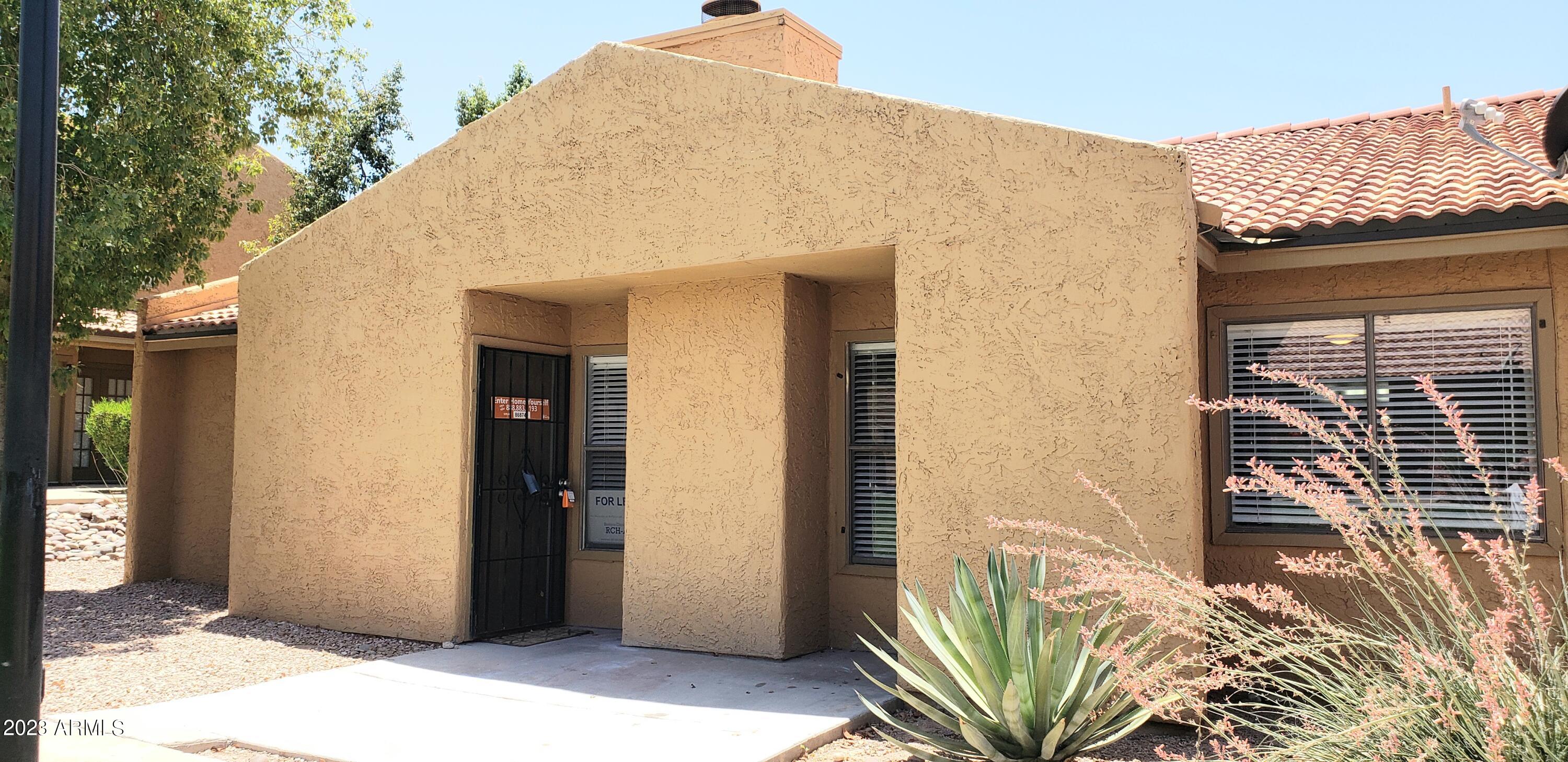 3511 East Baseline Road, Unit 1057 Phoenix, AZ 85042 - Photo 1 of 30 a view of a wooden door and outside of the house