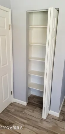 a view of walk in closet with empty racks