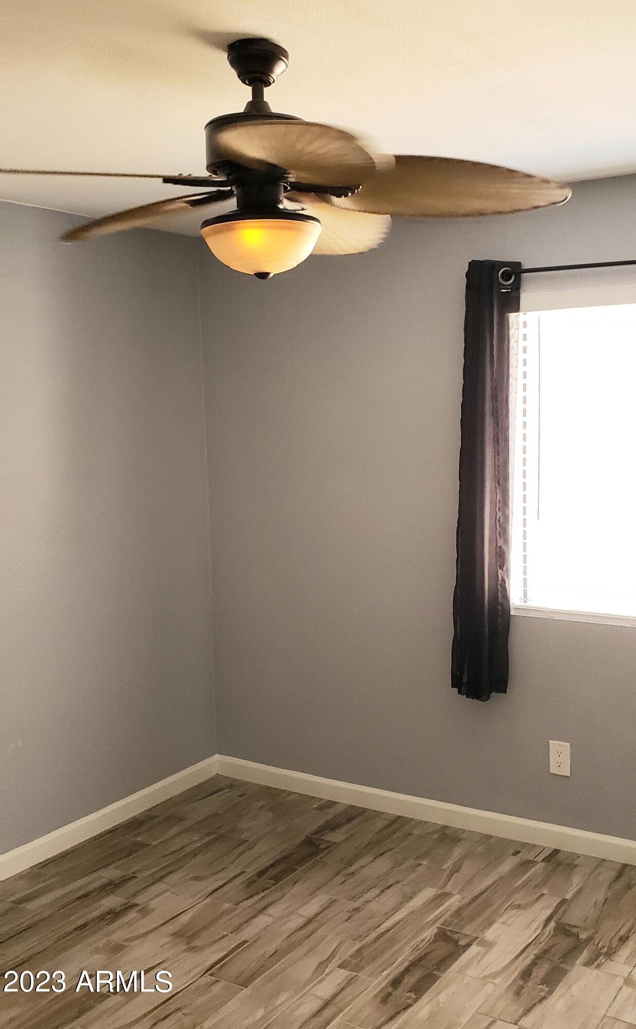 3511 East Baseline Road, Unit 1057 Phoenix, AZ 85042 - Photo 19 of 30 a view of a room with wooden floor