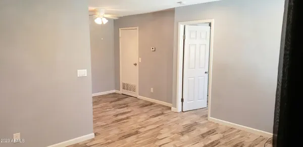 a view of an empty room with wooden floor