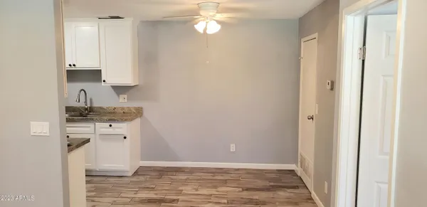 a view of a kitchen with white cabinets