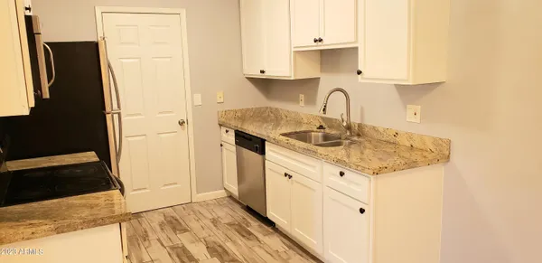 a view of a kitchen with sink and dishwasher