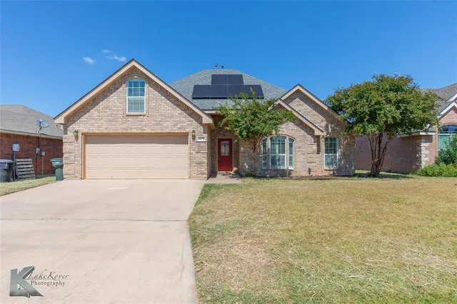 a view of a house with a yard and garage