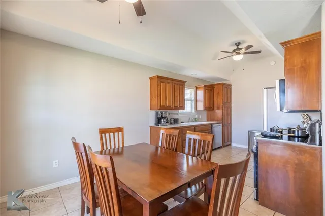 a view of a dining room with furniture and a chandelier