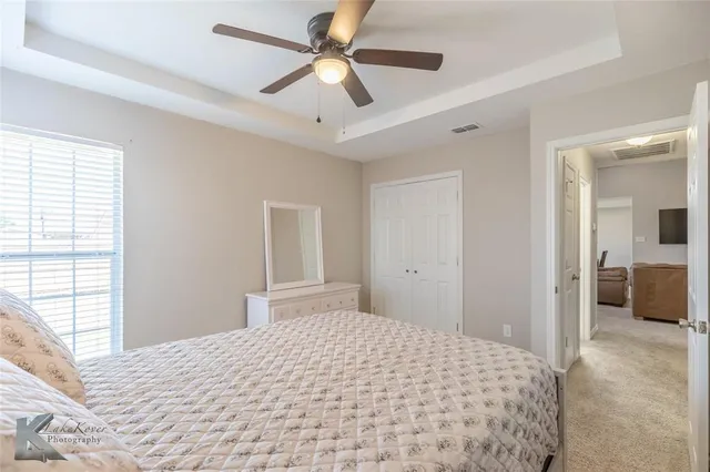 a bedroom with a large bed and a window