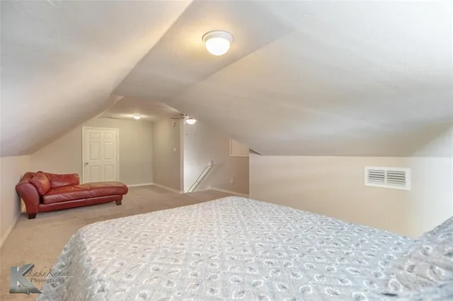 a bedroom with a bed and a couch