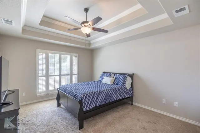 a spacious bedroom with a bed and window