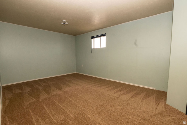 570 West Main Street Beaver, UT 84713 - Photo 27 of 43 Expansive room featuring wall-to-wall carpeting and light blue painted walls