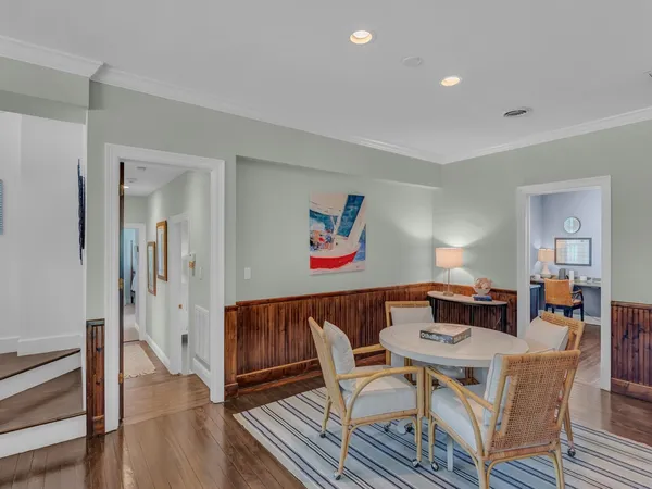 a dining room with furniture and wooden floor