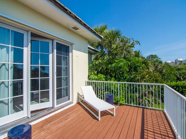a view of balcony with wooden floor and fence