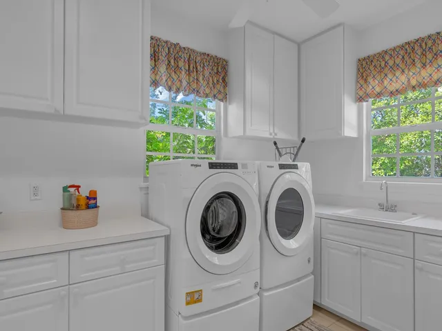 a utility room with sink dryer and washer