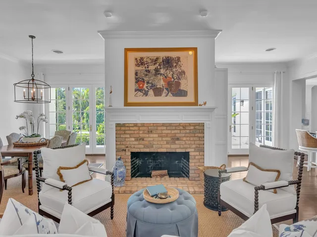 a living room with furniture a fireplace and a window