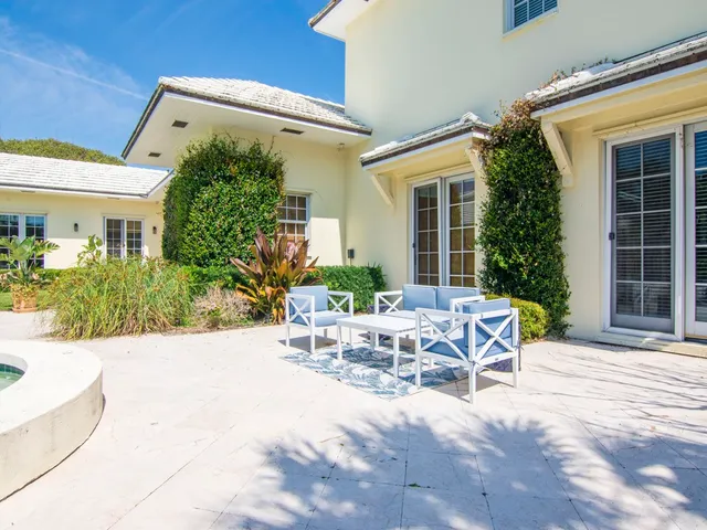 a view of a patio with table and chairs and potted plants