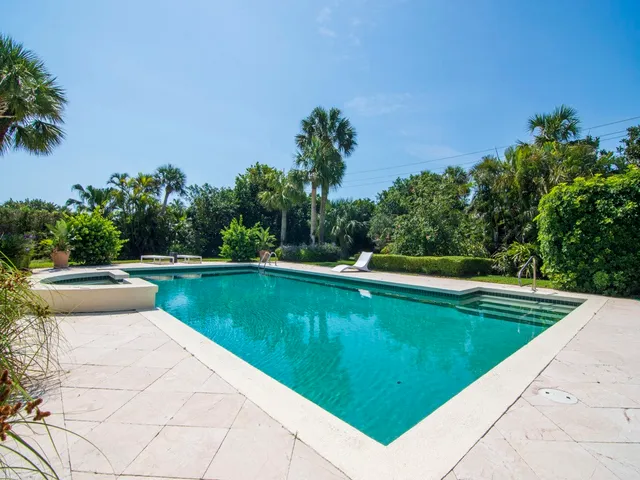 a view of a swimming pool with a yard