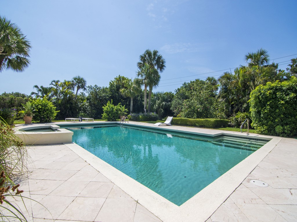 986 Riomar Drive Vero Beach, FL 32963 - Photo 32 of 36 a view of a swimming pool with a yard