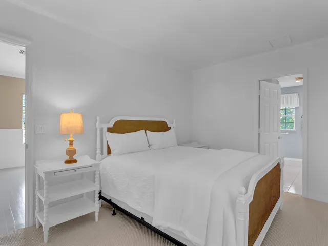 a bedroom with a bed and a lamp