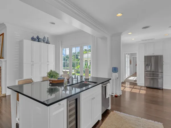 a kitchen with sink cabinets and wooden floor