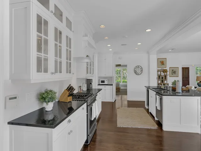 a kitchen with stainless steel appliances kitchen island granite countertop a sink and cabinets