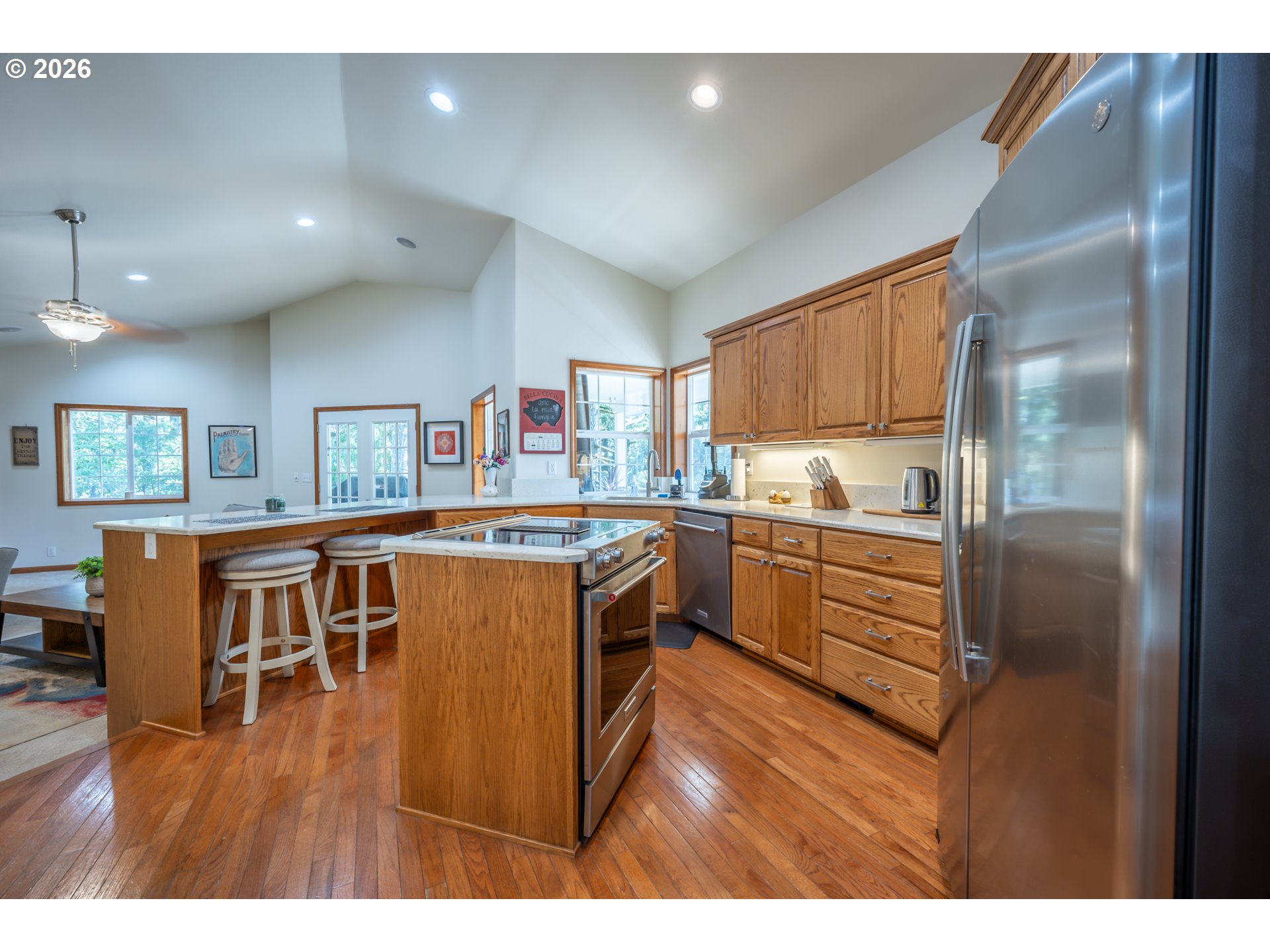 2193 13th Street Florence, OR 97439 - Photo 17 of 48 a kitchen view with stainless steel appliances granite countertop a refrigerator and a stove top oven