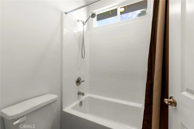 a bathroom with a bathtub and shower