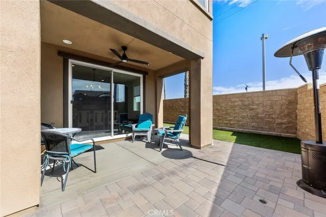 a building outdoor space with patio furniture and potted plants