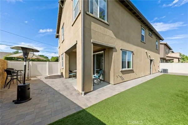 a view of a patio with table and chairs a barbeque