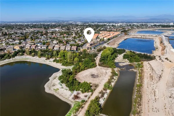 an aerial view of a house with a yard and lake view