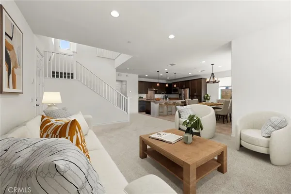 a living room with furniture and kitchen view