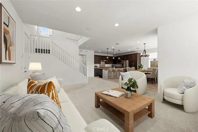 a living room with furniture and kitchen view