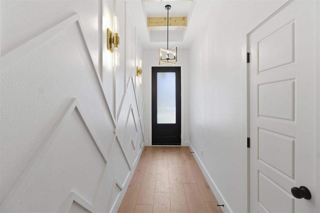 435 Waterboard Road Trinidad, TX 75163 - Photo 6 of 39 Hallway featuring geometric accent wall paneling and light wood-finish flooring