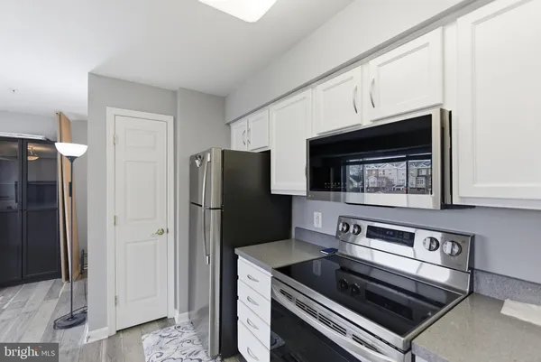 a kitchen with a refrigerator stove and cabinets