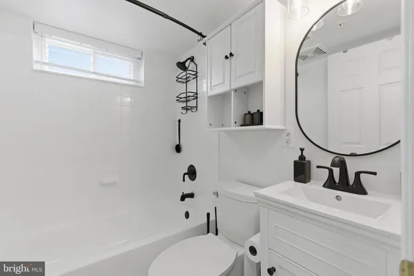 a bathroom with a sink a mirror a toilet and a mirror