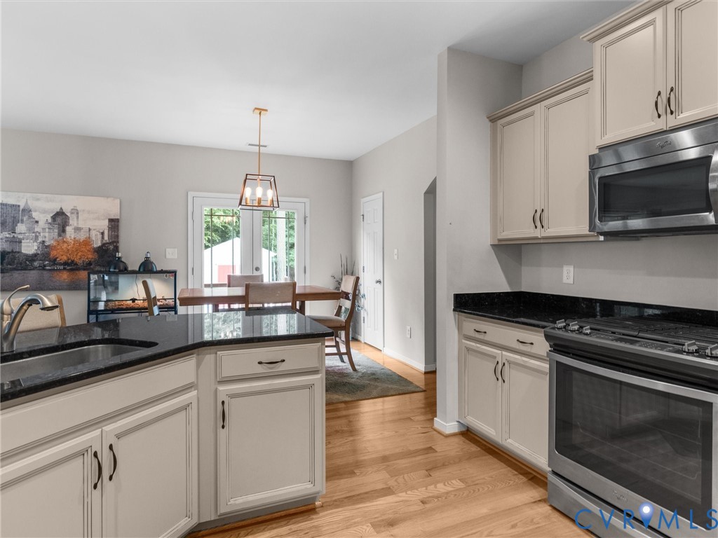 10824 Avening Road Chesterfield, VA 23832 - Photo 11 of 47 a kitchen with granite countertop a sink stove and cabinets