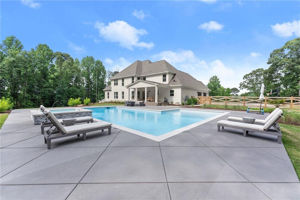 6998 Britt Gailey Road Clermont, GA 30527 - Photo 66 of 92 a view of a patio with swimming pool and table and chairs