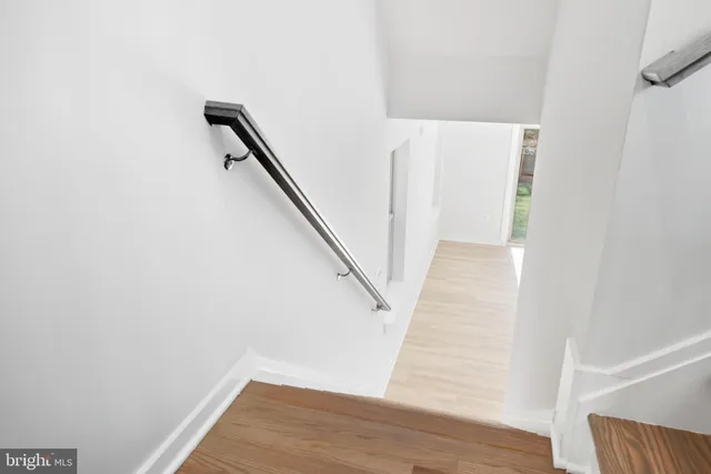 a view of a room with wooden floor and stairs