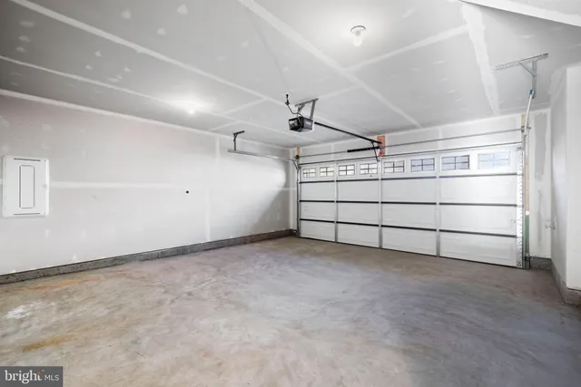 a kitchen with a window a sink and a microwave